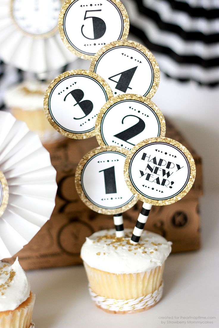 black and gold cupcake toppers on a cupcake.