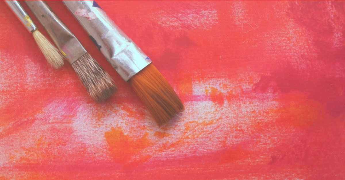 red background with three paintbrushes.