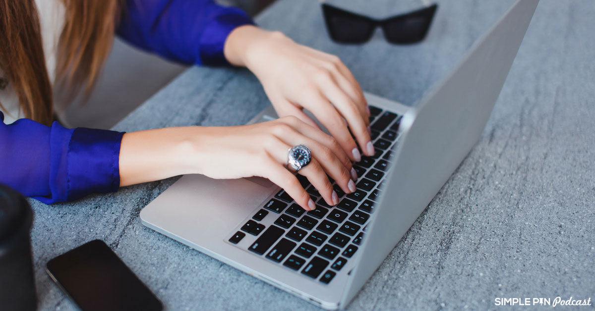 woman typing on laptop.