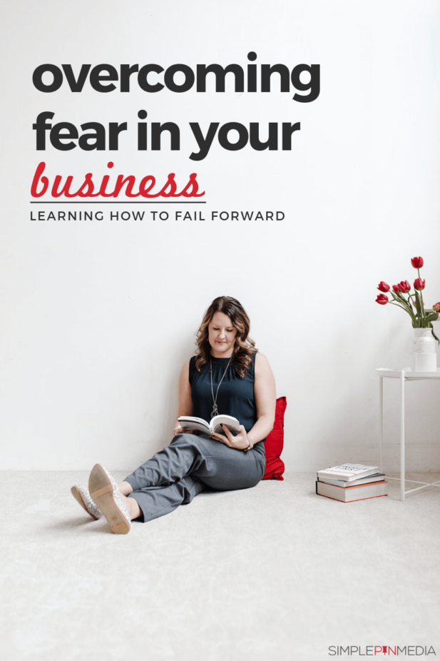 woman reading. text overlay reads "overcoming fear in your business".