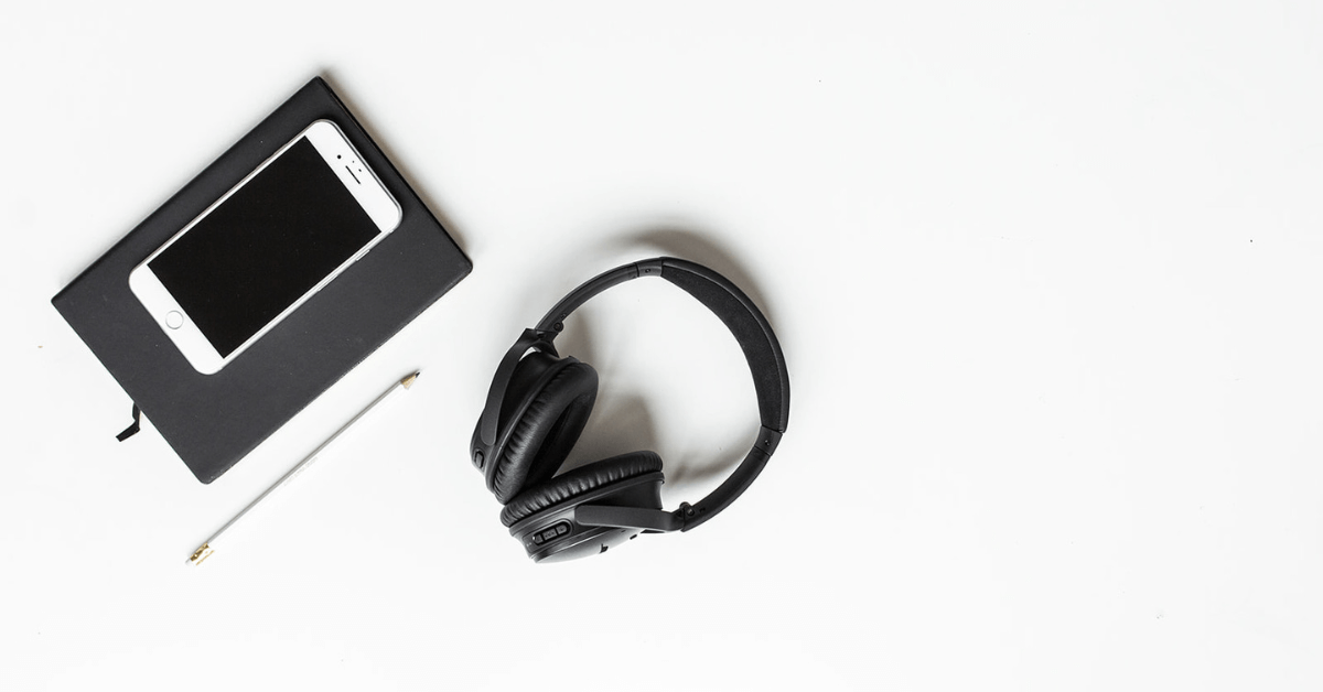 Cell phone and headset on desktop.