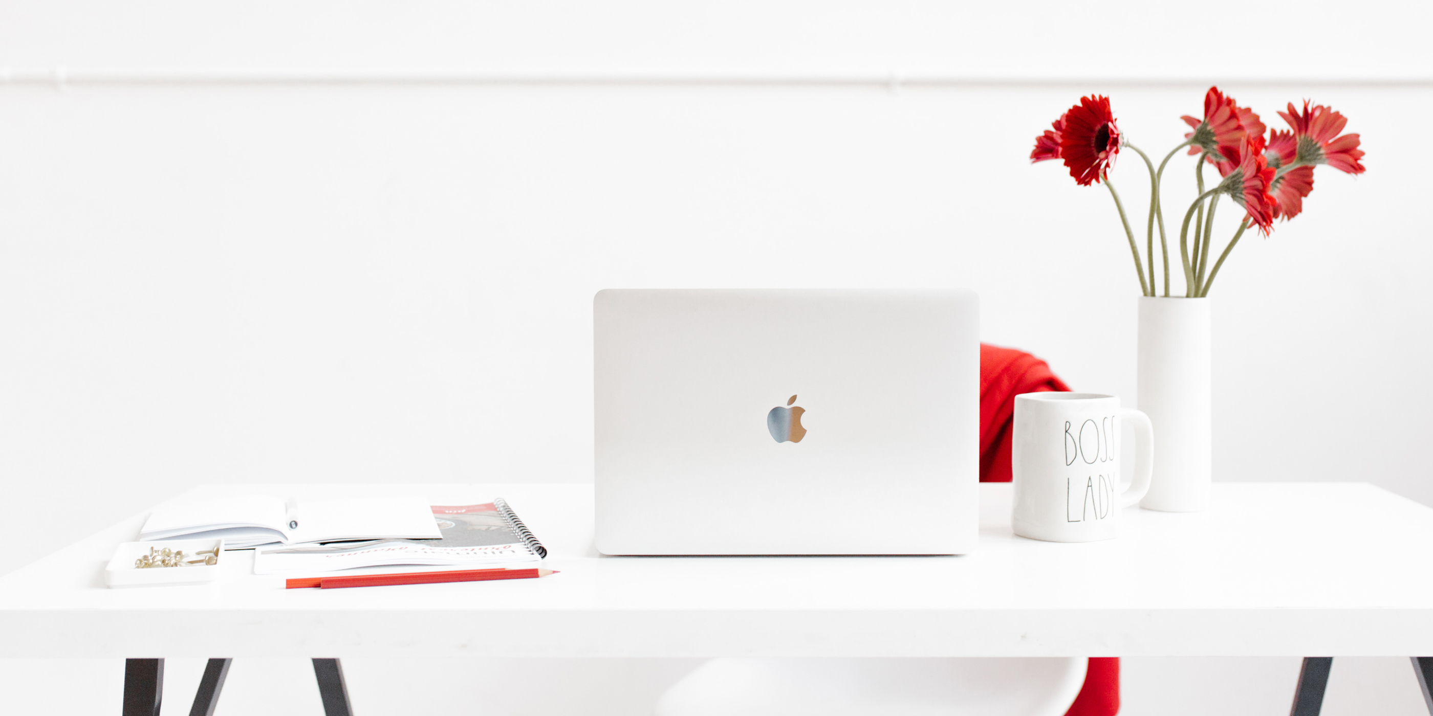 white desk with white and red accessories.