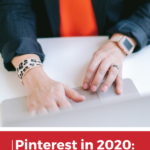 woman typing on laptop with text overlay "Pinterest in 2020: Setting Pinterest Marketing Goals"
