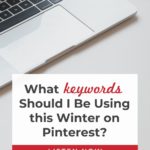 desk with laptop - text "what keywords should I be using this winter on Pinterest?".