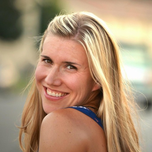 girl with blond hair turning head over shoulder.