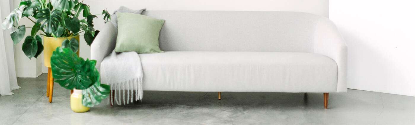 white sofa with green pillows.