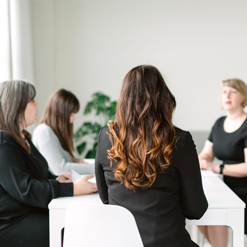 Simple Pin media team sitting around a table.