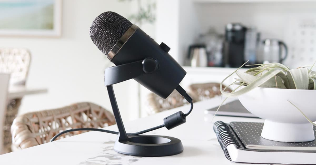 black microphone sitting on white table.