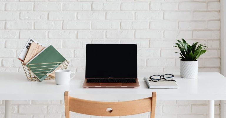 laptop on white table.