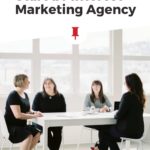 four women sitting around table with text "what it looks like to start a pinterest marketing agency".