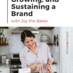 woman in kitchen with spatula with text - "starting, growing, and sustaining a brand with joy the baker".