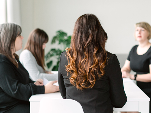 Simple PIn Media team members sitting at a conference table.