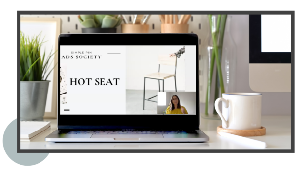 laptop open on table with text "hot seat".