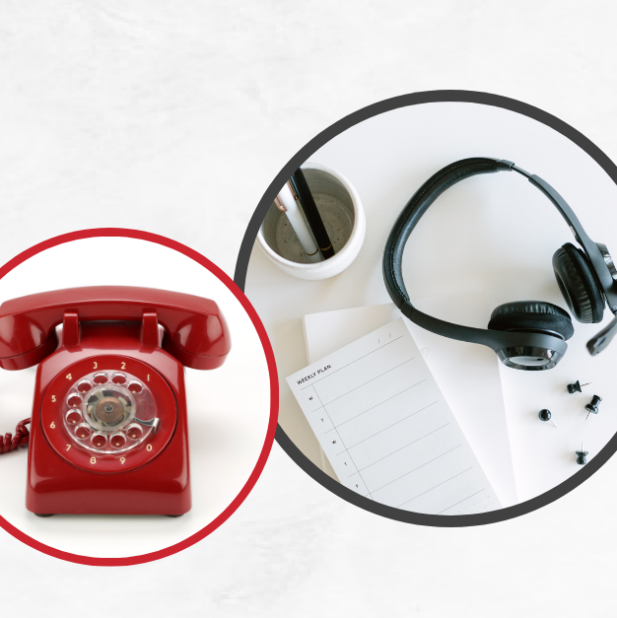 red rotary phone next to headphones on a table.