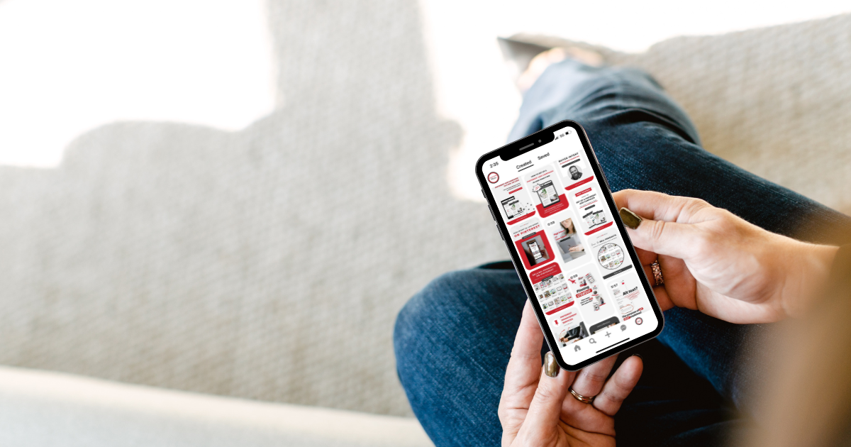 A top-view of a pair of hands holding an iPhone. Pinterest search feed is shown.