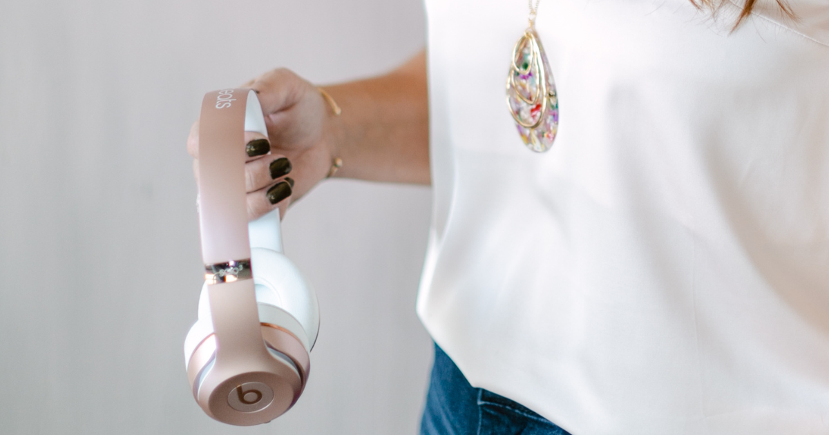 Woman hands holding a pair of beats headphones.