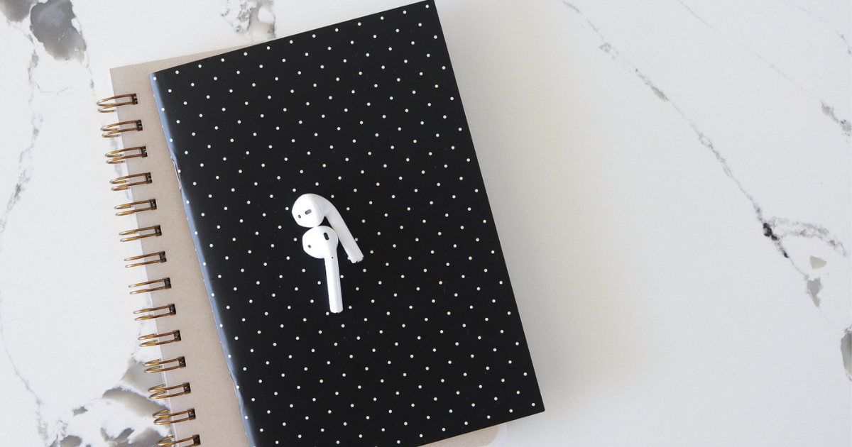 A black and white polka dot notebook sits on a counter.