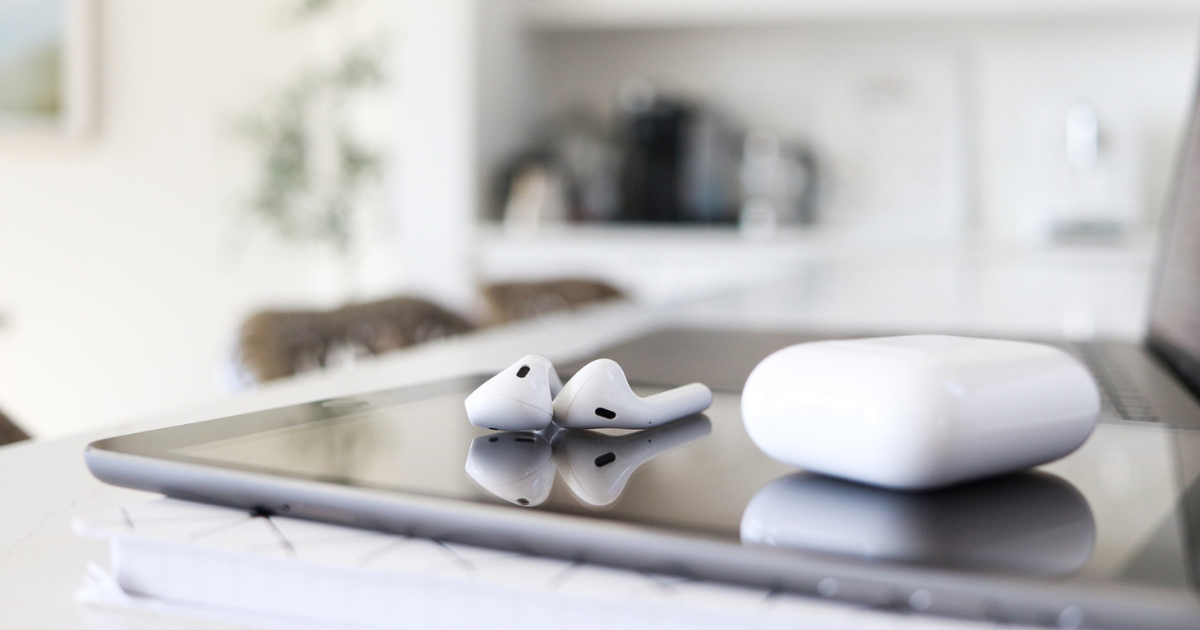 A pair of airpods sitting on a counter.