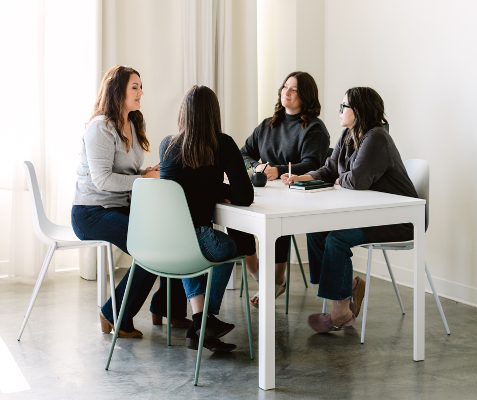 Women sitting at a table. 