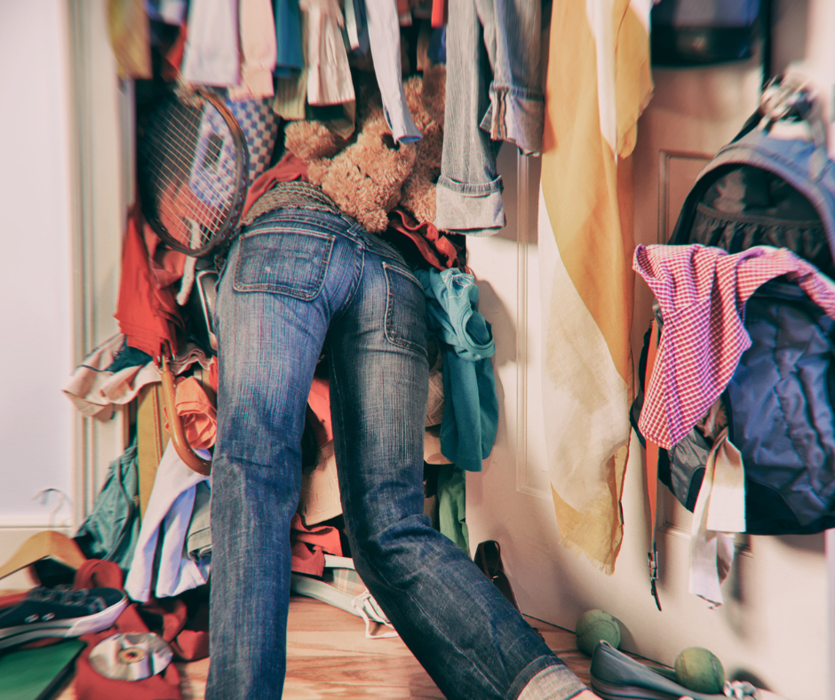 Image shows a person lost in a messy closet.