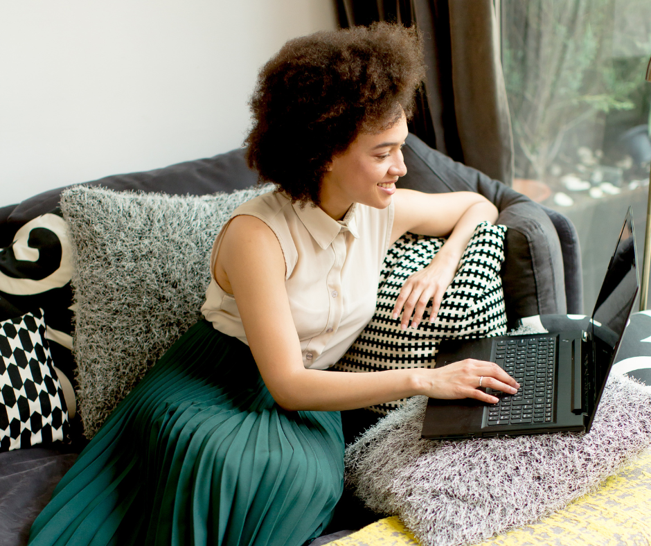 Image shows a woman typing on a computer.