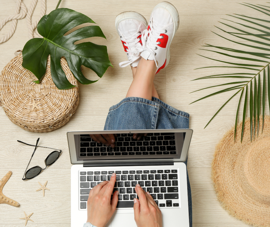 Image shows a person holding a laptop.