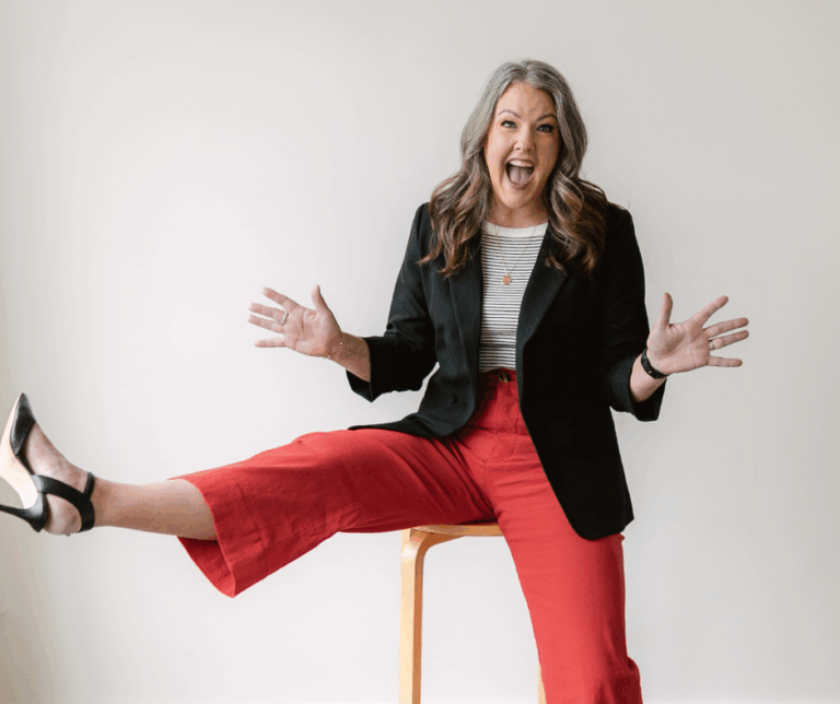 Image shows a woman sitting on a stool.