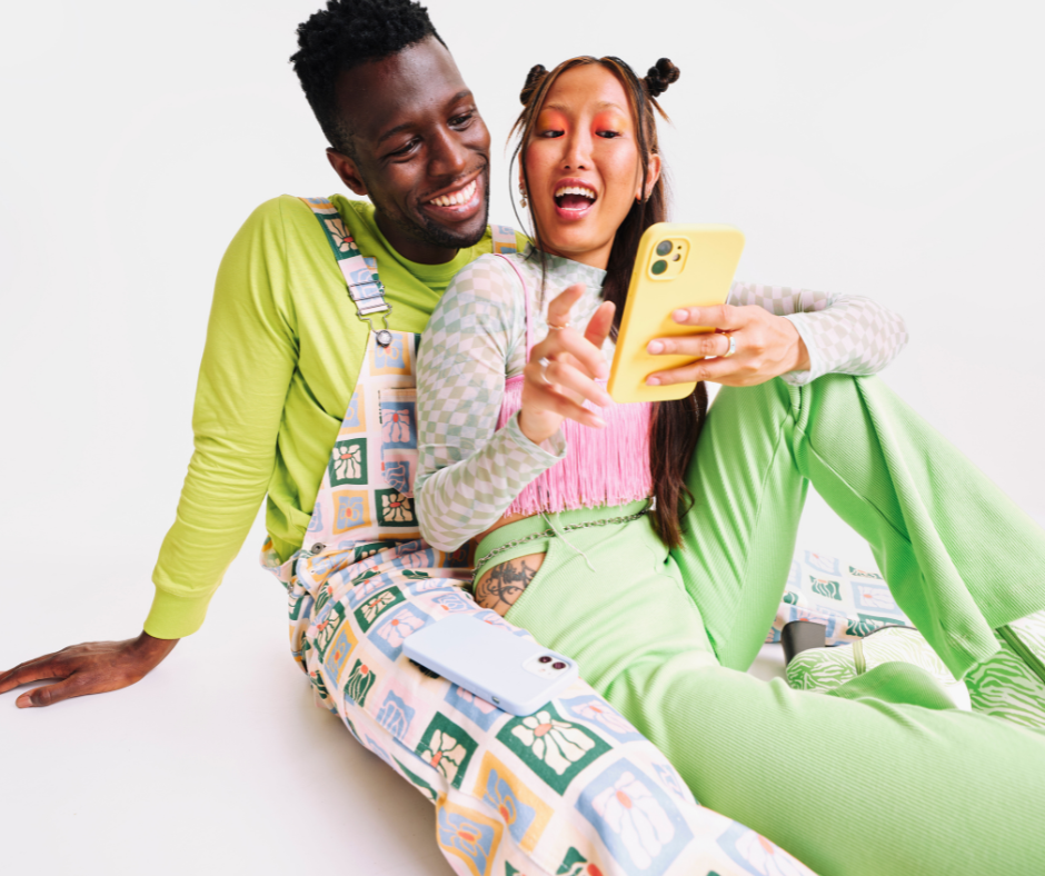 Image shows a couple looking at a phone.